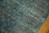 Distressed pile texture of vintage Tabriz carpet, revealing faded teal and wine red Herati pattern.