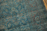 Faint foundation showing through distressed sapphire blue and wine red Herati motif.