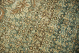 Herati motif field in dusty teal and pale coffee brown with even wear and exposed foundation.