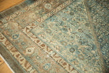 Distressed vintage Malayer carpet with faded ocean green, teal, and beige textures.