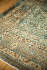 Distressed vintage Malayer carpet, showing faded ocean green blue, beige, and visible wear.