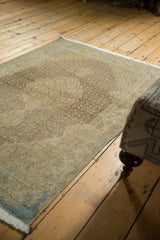 Corner detail of distressed Tabriz rug, with fine curvilinear border and even wear.