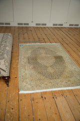 Distressed Tabriz rug with softened Herati motif in coffee, sand, and ivory tones.