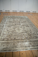 Distressed Mahal carpet with worn pile, visible foundation, scrolling leaves and pinwheel patterns.