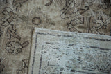 Distressed pile with dark patterns and visible hand-knotted foundation of the Mahal carpet.