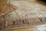 Antique Distressed Sultanabad rug's border, featuring oversized palmettes, madder red, blue, and visible wear.