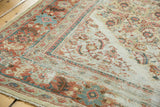 Distressed antique Sultanabad rug detail with terracotta, sky blue Herati patterns and wide floral border.