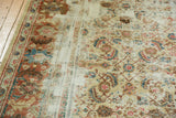 Distressed antique Sultanabad carpet's textured pile and visible foundation showing Herati design.
