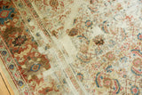 Distressed antique Sultanabad rug showcasing worn Herati motif and exposed foundation.