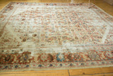 Distressed wide border of the antique Sultanabad carpet, featuring terracotta palmettes and evident wear.