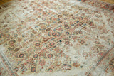 Distressed antique Sultanabad carpet with Herati pattern, ivory, red, blue, and border palmettes.