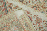 Folded antique Sultanabad carpet, revealing an allover Herati pattern, worn pile, and woven foundation.