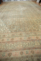 Close-up distressed vintage Bibikabad rug, muted sand, blush, oxidized silver Herati pattern.