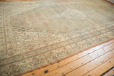 Decorative distressed corner of vintage Persian Bibikabad carpet with soft, faded Herati borders.