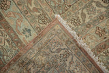 Distressed vintage Bibikabad carpet corner with worn Herati pattern, fringe, and backing visible.
