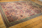 Antique Kerman rug corner, showing intricate floral palmettes and ornate borders.