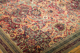 Antique Kerman carpet's intricate floral border and sprawling field with palmette motifs.