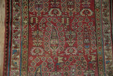 Detailed view of the Malayer rug's hand-knotted boteh design and multi-layered border.
