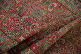 Soft folds reveal the distressed pile and repeating boteh motif of the vintage Persian runner.