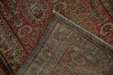 Corner view of a vintage Malayer runner showing the hand-knotted back and low copper-red pile.