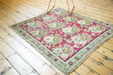 Pale bronze starburst border and raspberry cochineal red rose field on antique Karabagh rug.