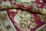 Antique Armenian Karabagh rug detail: raspberry rose bouquet field and starburst border.