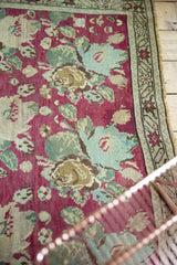 Armenian Karabagh rug detail: raspberry cochineal field, pale blue rose bouquets, starburst border.