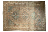 Distressed vintage Kamseh carpet, interconnected medallions in sand beige and dusty blue.