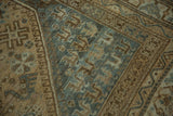 Worn pile and angular patterns in soft beige and dusty slate blue on the Kamseh rug.