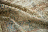Distressed texture and intricate curvilinear motifs in muted pale yellow, sky blue, and blush.