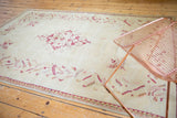 Ivory field with raspberry red inwardly pointed floral bouquets and serrated leaf border.