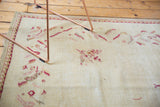 Ivory field, raspberry floral bouquets, and serrated leaf border on a Turkish Oushak rug.