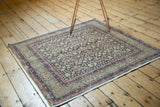 Distressed Turkish Sparta rug corner: blush pink turtle border, navy trellis field, mostly even wear.