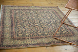 Distressed vintage Sparta rug showing trellis vinery and blush pink turtle border motif.