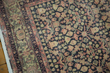 Distressed navy, blush pink, and ivory trellis vinery on a vintage Sparta rug.
