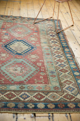 Distressed geometric border featuring red, blue, green hook and latch motifs.