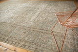 Distressed Meshed carpet texture with faded floral designs in silver, seafoam, and ivory.