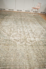 Faded floral vinery in muted ivory and seafoam, showing the distressed foundation.