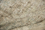 Distressed Meshed carpet showing worn texture, faded floral design, antique ivory and seafoam.
