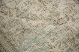 Time-softened texture with faded floral patterns in antique ivory and dusty seafoam.