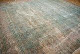 Vintage distressed Tabriz carpet showing artistic wear with faded powder blue and raspberry vinery.