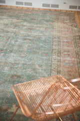 Section of distressed Tabriz rug, featuring soft powder blue, dusty raspberry, and intricate floral vinery.