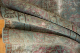 Distressed Tabriz rug pile showcasing faded powder blue and dusty raspberry patterns.