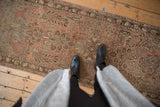 Muted dusty rose and coffee brown floral motifs on a distressed Lilihan runner.