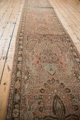Distressed Lilihan runner's short pile, revealing dense floral vinery in dusty rose and coffee brown.