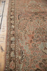 Close-up of the vintage Lilihan runner's intact brown selvage, short pile, and faded floral design.