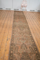 Side view of vintage Lilihan runner showing its distressed floral vinery and rich border.
