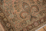 Corner of distressed Lilihan rug runner, showing short pile, dusty rose field, and detailed floral vinery.