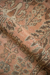 Short pile and distressed floral pattern detail in dusty rose and coffee brown.