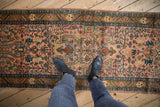 Overhead view showing the scale of the vintage Lilihan runner's dusty rose and navy pattern.